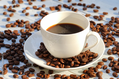 Coffee cup and coffee beans on the table 