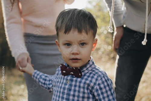 Portrait of a handsome boy with a stylish bow tie. Boy with green eyes.