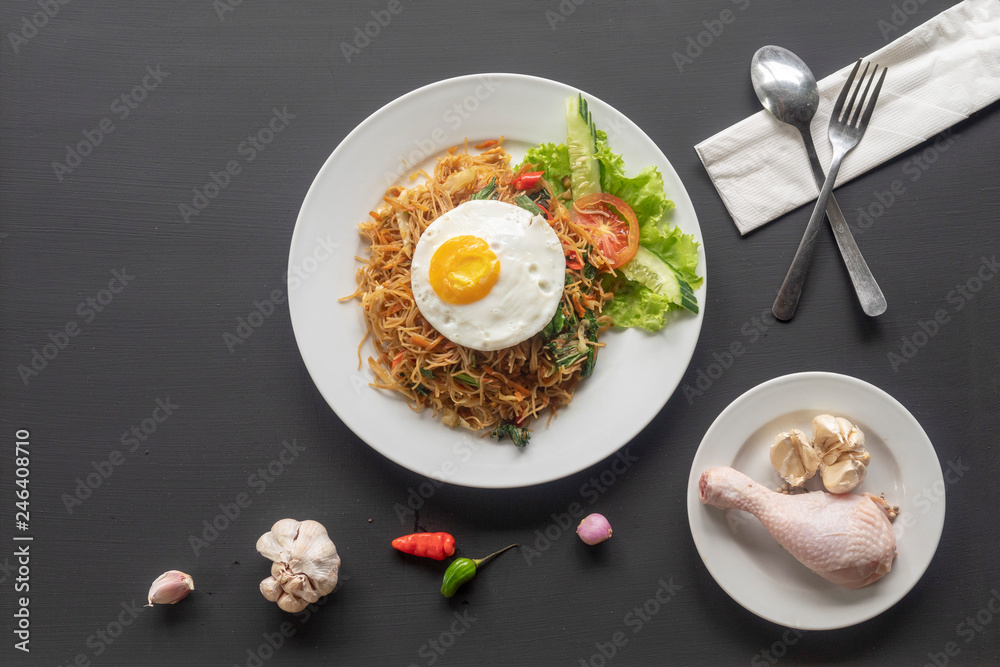 Asian dish fried noodles with egg and seafood or beef or chicken