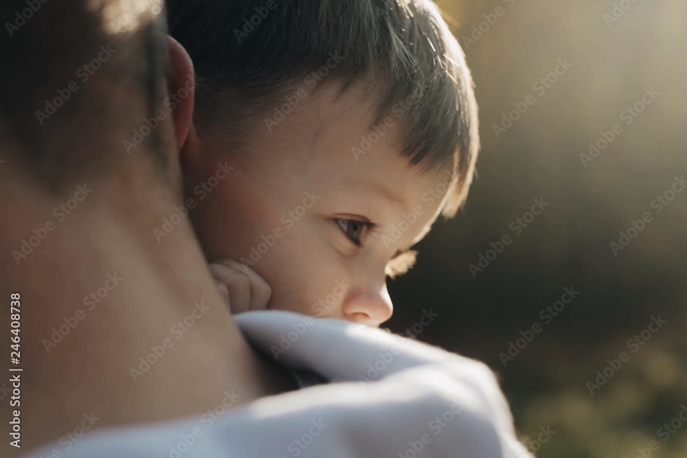 Son hugs father lying on the shoulder Son hugs father lying on the shoulder