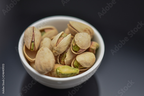 Roasted pistachio seeds with shell in bowl