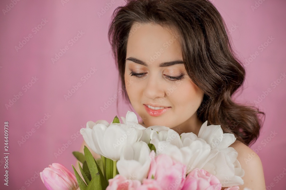 Young woman Bouquet of Tulips Smiling Girl Portrait Spring Pink background Holidays