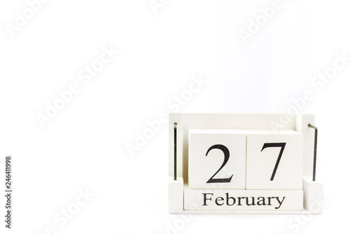 the day of February on a white clear background. a wooden desktop calendar that reminds us of what date we are today.
