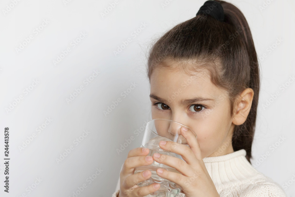 Happy child girl drinking pure water from glass. Happy child girl drinking pure water from glass.