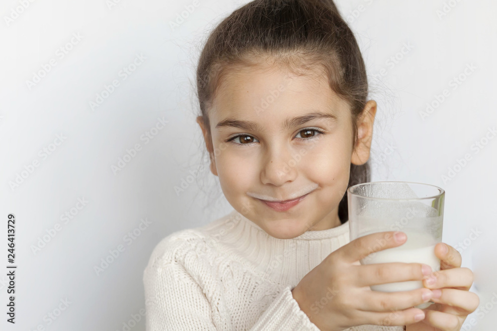 Happy child girl drinking yogurt. Whiskers from yogurt. Happy child girl drinking yogurt. Whiskers from yogurt.