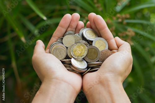 coins in human hands, Save money for the future business, investment and finance concept