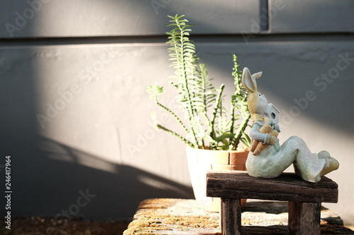 closedup rabbit doll for decorate garden  sit on the wood chair in the garden photo