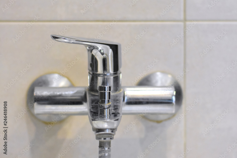 Dirty chrome faucet with selective focus on blurred background. Steel bathroom faucet with dirty silver surface. Mold or fungus at the blurred bathroom wall. Stainless design shower Dirty chrome faucet with selective focus on blurred background. Steel bathroom faucet with dirty silver surface. Mold or fungus at the blurred bathroom wall. Stainless design shower