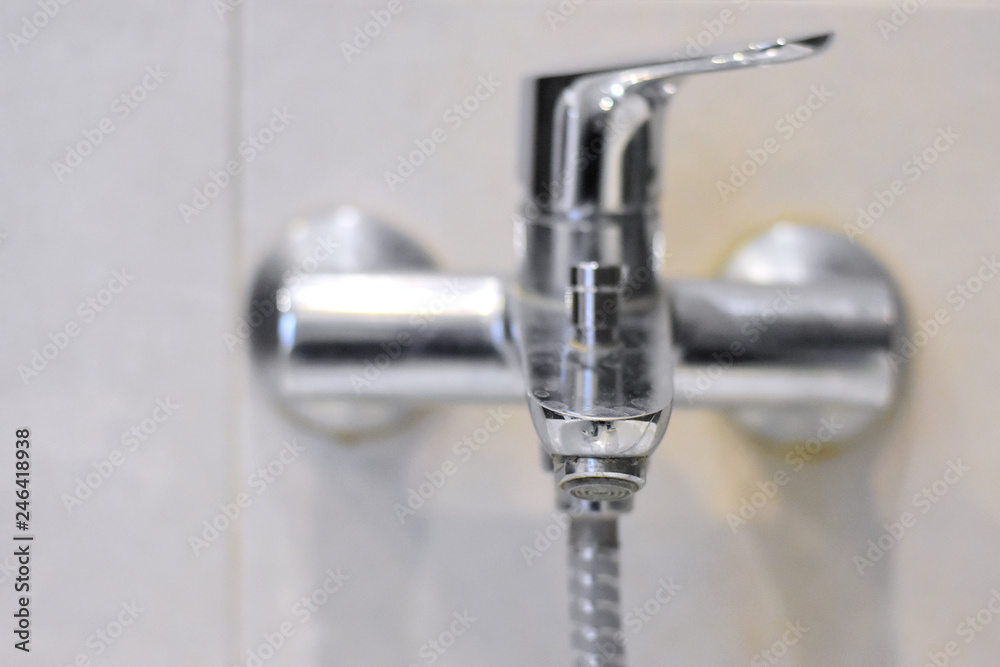 Dirty chrome faucet with selective focus on blurred background. Steel bathroom faucet with dirty silver surface. Mold or fungus at the blurred bathroom wall. Stainless design shower Dirty chrome faucet with selective focus on blurred background. Steel bathroom faucet with dirty silver surface. Mold or fungus at the blurred bathroom wall. Stainless design shower