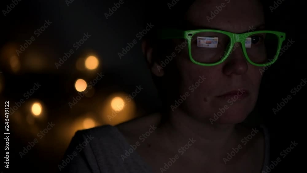 Low key portrait of busy woman working on laptop computer at night from her home office Low key portrait of busy woman working on laptop computer at night from her home office
