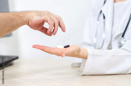 Woman physician giving patient prescribed dose of medication