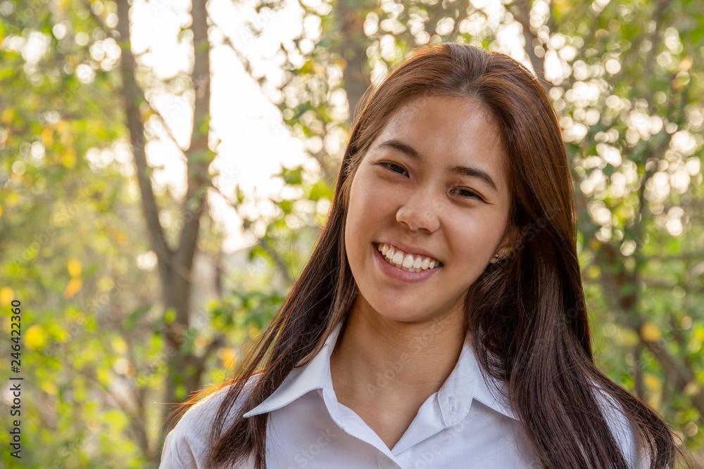 Portrait of asian college woman smiling in blur background witn sunlight. Portrait of asian college woman smiling in blur background witn sunlight.
