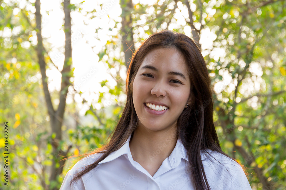 Portrait of asian college woman smiling in blur background witn sunlight. Portrait of asian college woman smiling in blur background witn sunlight.