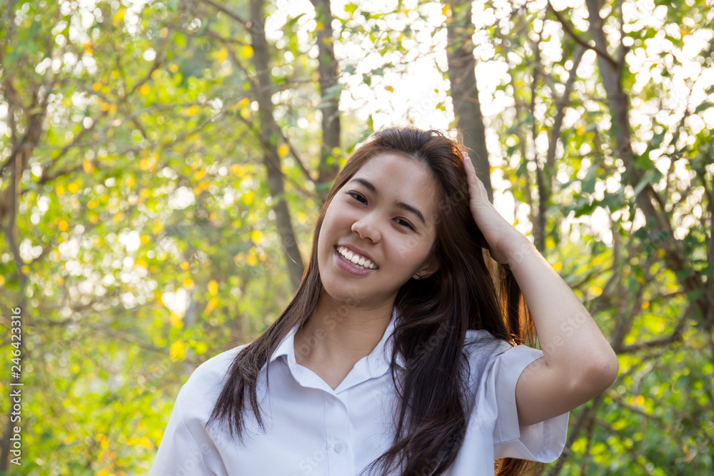 Portrait of asian college woman smiling in blur background witn sunset. Portrait of asian college woman smiling in blur background witn sunset.