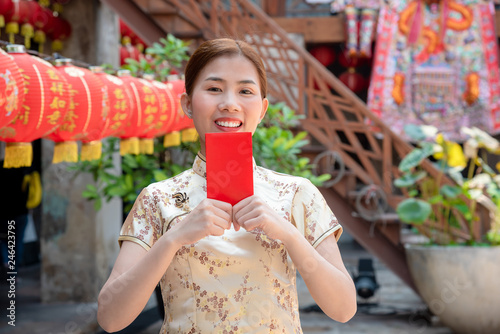 happy Chinese new year.Happy asian woman in chinese traditional dress and holding red envelope
