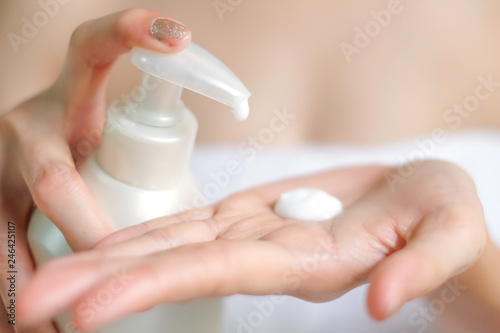 Woman applying moisturizing cream/lotion on hands, beauty concept.