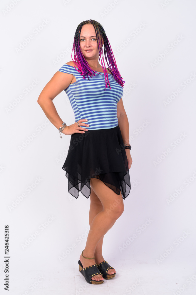 Full body shot of happy rebellious woman with dreadlocks smiling Full body shot of happy rebellious woman with dreadlocks smiling