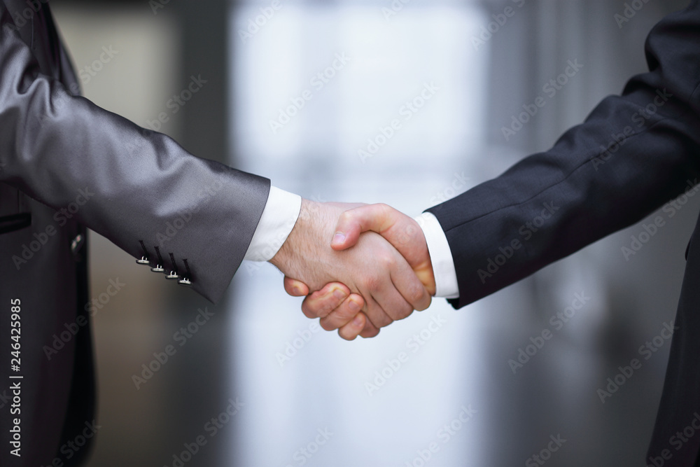 close up.handshake of business partners on the background of the office