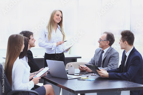 Businesswoman explaining business plan to her colleagues