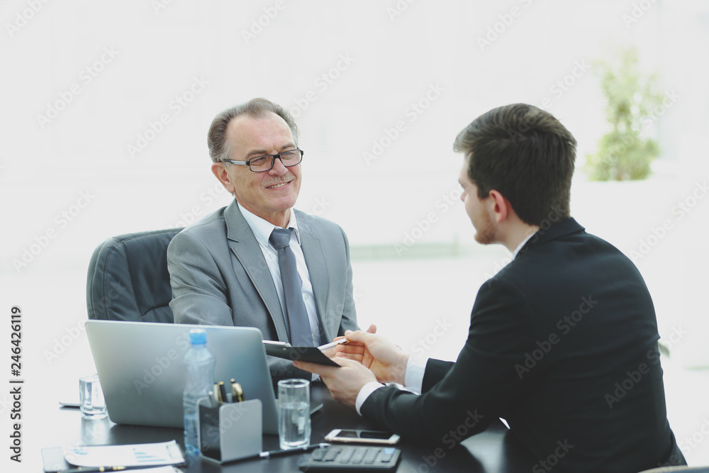 close up.business people talking at a Desk. close up.business people talking at a Desk.
