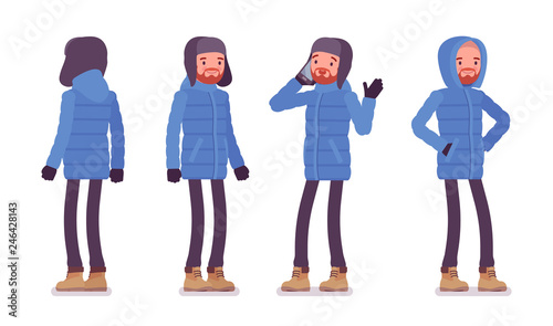 Stylish man in a blue down jacket standing