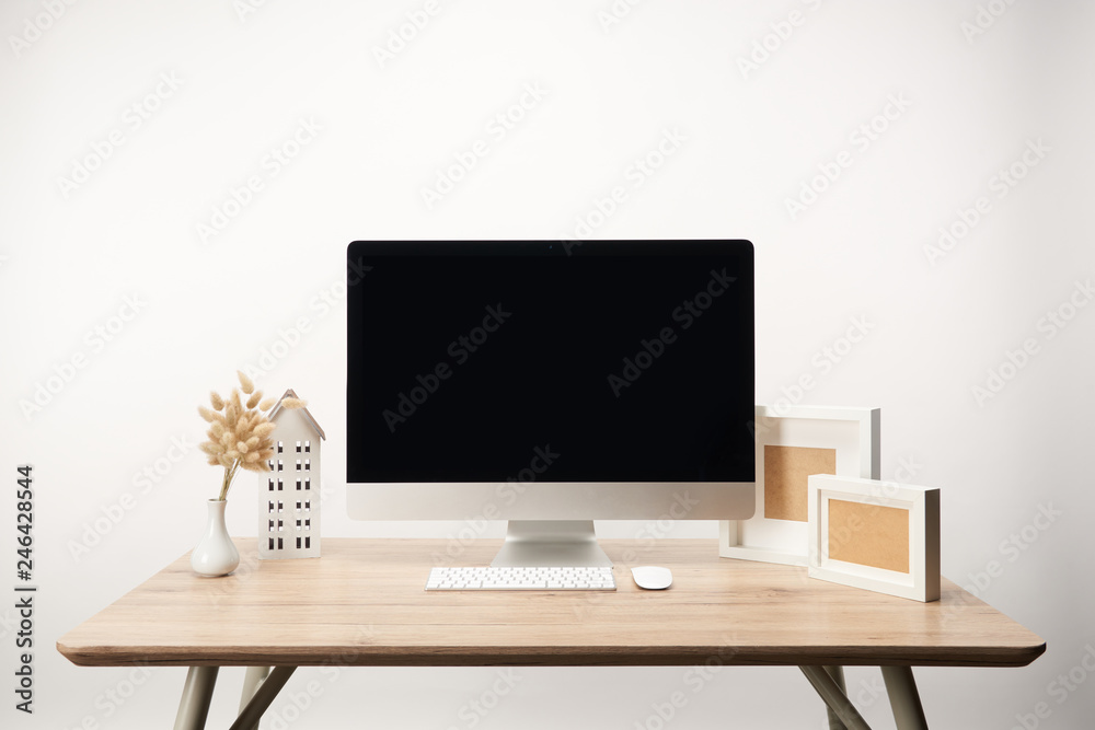 workplace with photo frames, dry flowers and desktop computer with copy space isolated on white workplace with photo frames, dry flowers and desktop computer with copy space isolated on white