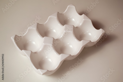 White ceramic egg holder without eggs.