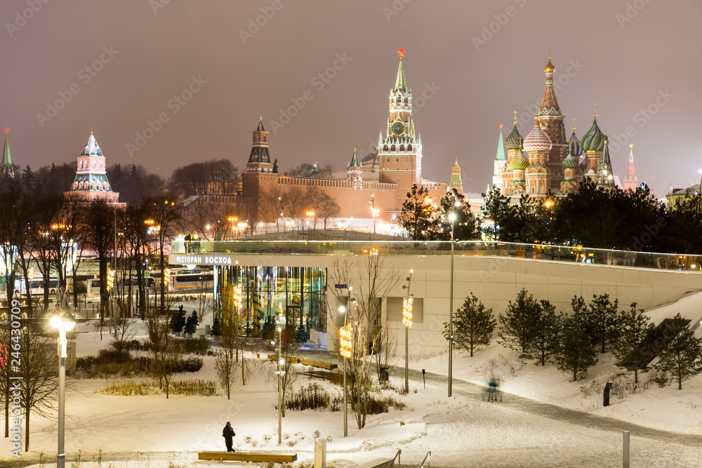 Moscow, Russia - January, 2019: Festively decorated for winter holidays the pier on Moskvoretskaya embankment of river Moskva (Moscow) and hovering bridge of Zaryadye Park.
