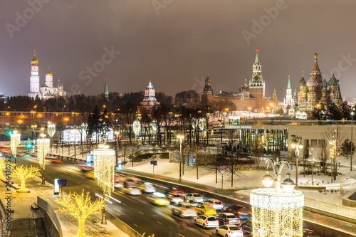 Moscow, Russia - January, 2019: Festively decorated for winter holidays the pier on Moskvoretskaya embankment of river Moskva (Moscow) and hovering bridge of Zaryadye Park.