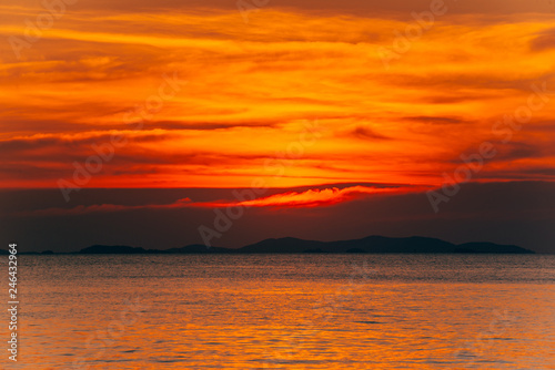 Beautiful blazing sunset landscape and orange sky above it summer background.