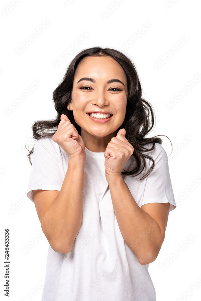 happy asian smiling woman holding fists close to face isolated on white happy asian smiling woman holding fists close to face isolated on white