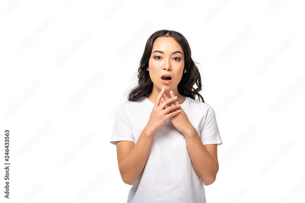 worried asian woman in white t-shirt holding hands near face isolated on white worried asian woman in white t-shirt holding hands near face isolated on white