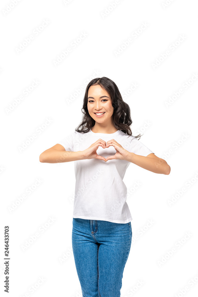 Smiling asian woman showing heart sign with hands isolated on white