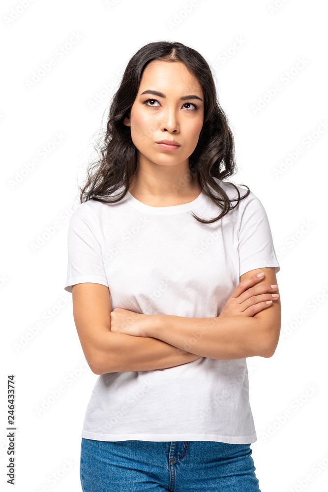 Skeptical dissatisfied asian woman standing with crossed arms isolated on white Skeptical dissatisfied asian woman standing with crossed arms isolated on white