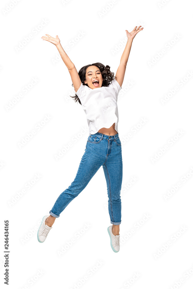 Happy young asian woman jumping up with raised hands isolated on white