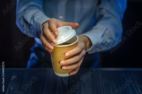 Barista serves coffee to the client. Hands Paper cup Bar counter Cappuccino Plastic cap. Coffee Business Concept