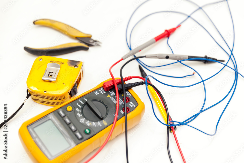 voltmeter, pliers and measuring tape voltmeter, pliers and measuring tape