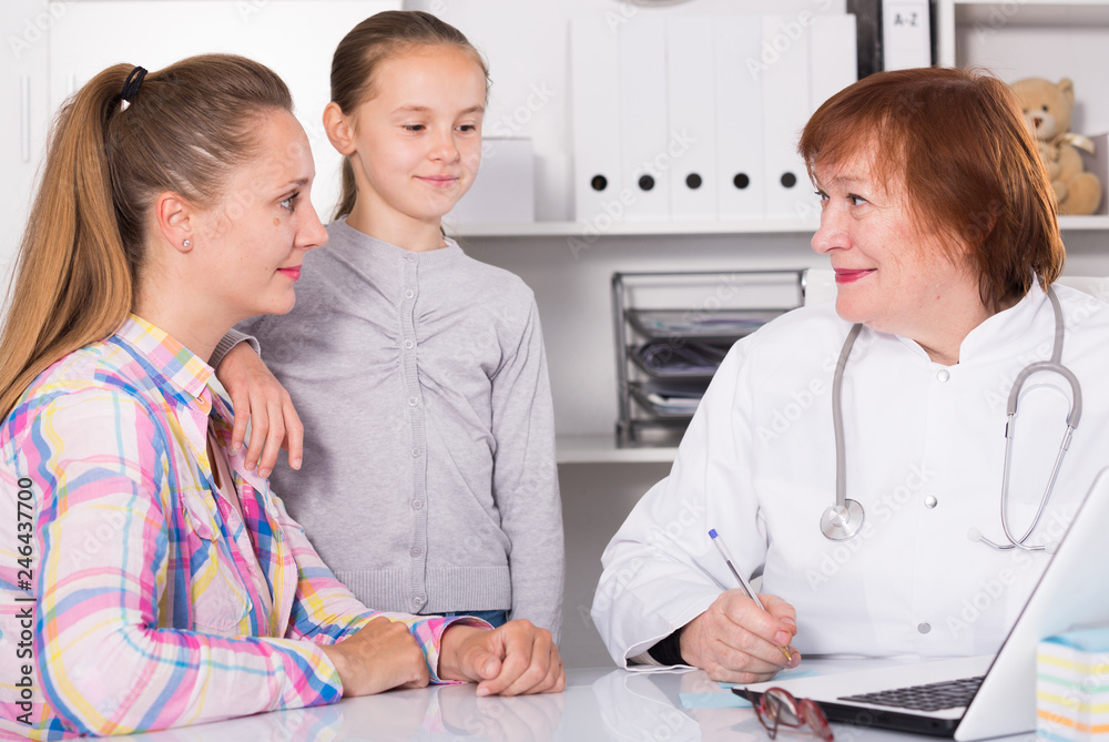 Fototapeta premium Little girl and mother with mature medical worker