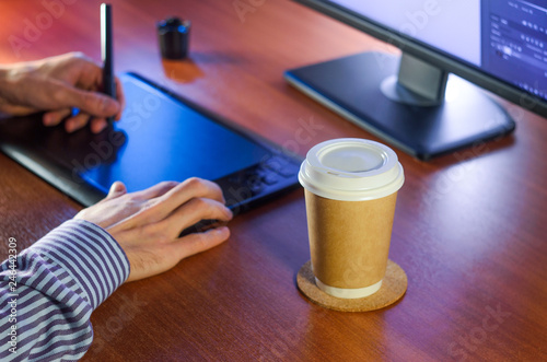 Desktop side view. Computer Graphics Tablet Cup of coffee Hand. Concept for website banner  mockup  background  presentation and marketing material