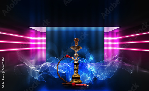 Smoking hookah on the background of an empty room. Multicolored neon light. Searchlight, laser blue and pink rays, smoke.
