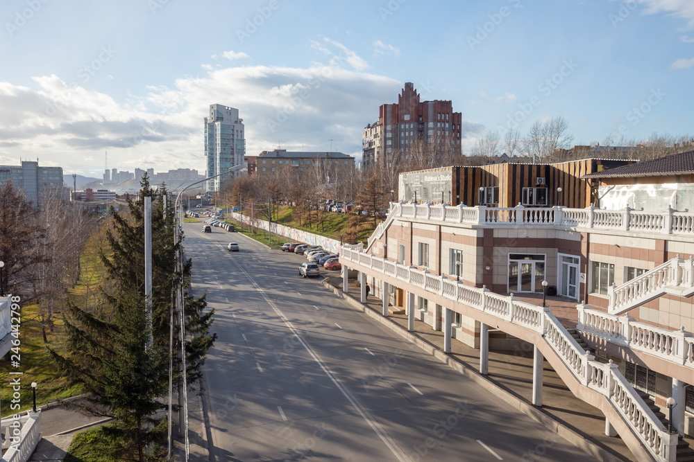 Fototapeta premium View of the roadway on Dubrovinsky Street with residential buildings in the distance in the city of Krasnoyarsk. Russia.