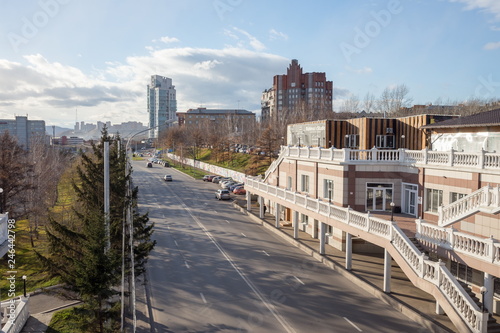 View of the roadway on Dubrovinsky Street with residential buildings in the distance in the city of Krasnoyarsk. Russia.