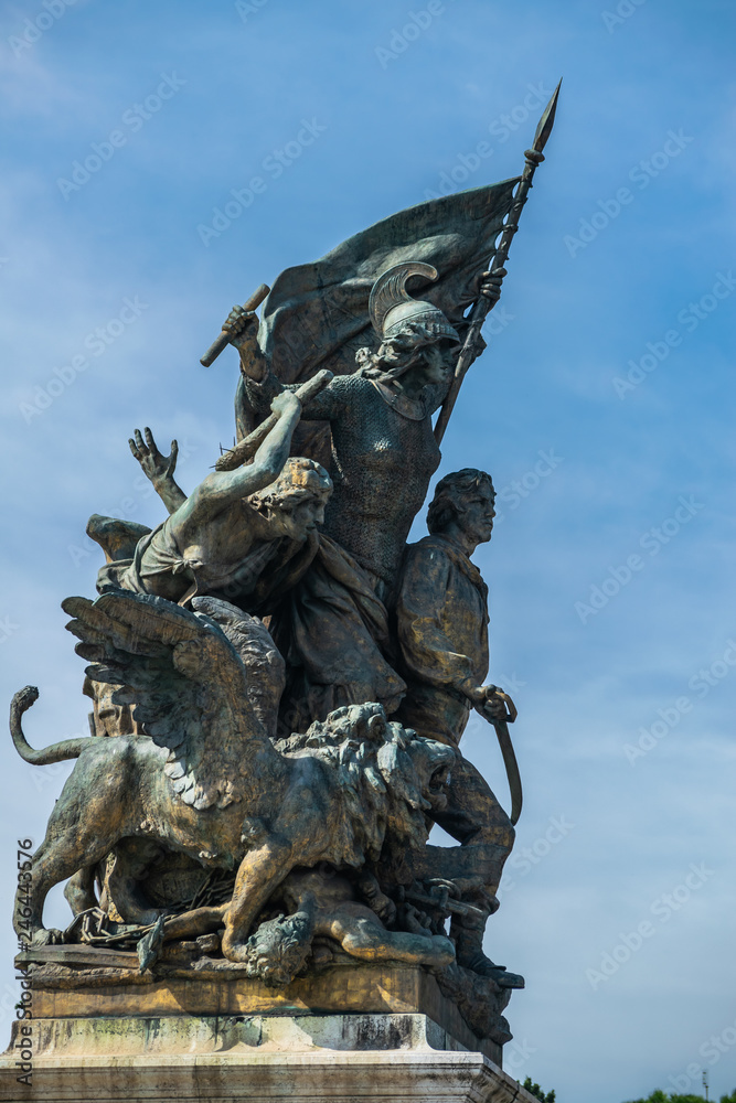 Obraz premium Sculptural composition Il Pensiero (Statue of the Thought) with italian flag in front of it on the left of staircase of Vittorio Emanuele II Monument in Rome. Italy