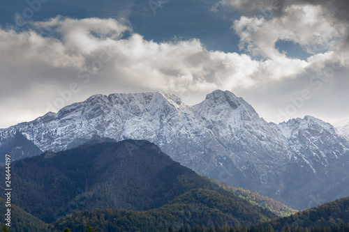 Giewont Mountain in polish Tatra Mountains covered with snow under cloudy sky