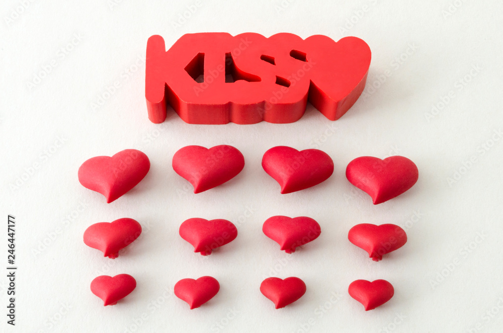 The word kiss and little red hearts against white background. Valentines Day decoration The word kiss and little red hearts against white background. Valentines Day decoration