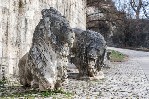 Sculpture of marble lions, a symbol of the city of Brescia, are installed in the park of the castle. Lombardy, Italy. © Artem
