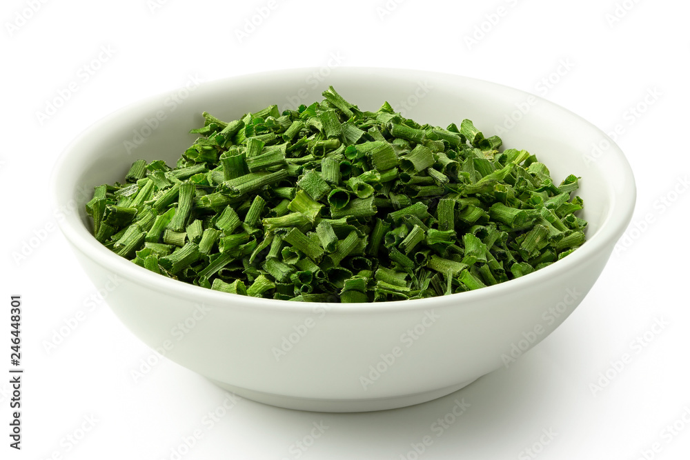 Dried chopped chives in white ceramic bowl isolated on white. Dried chopped chives in white ceramic bowl isolated on white.