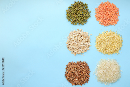 Multi-colored cereals on a blue background, copy space