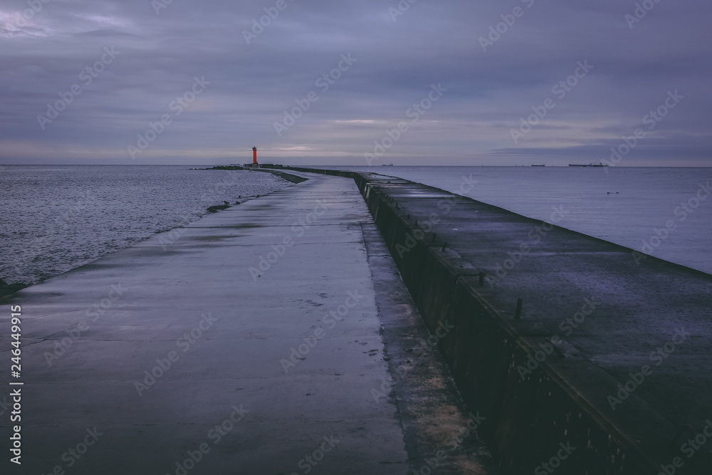 Sea pier in a dark, dreary evening