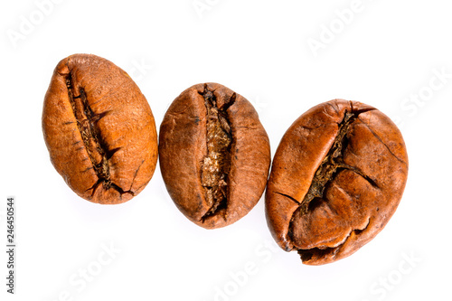 Coffee beans. Three medium roasted coffee beans maccro view, close up, isolated on white background.